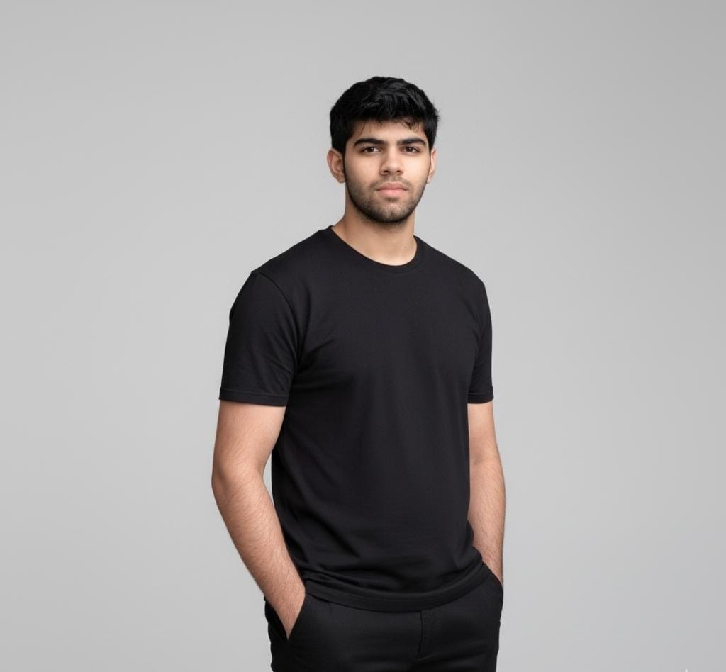 Man wearing a black t-shirt against a gray background