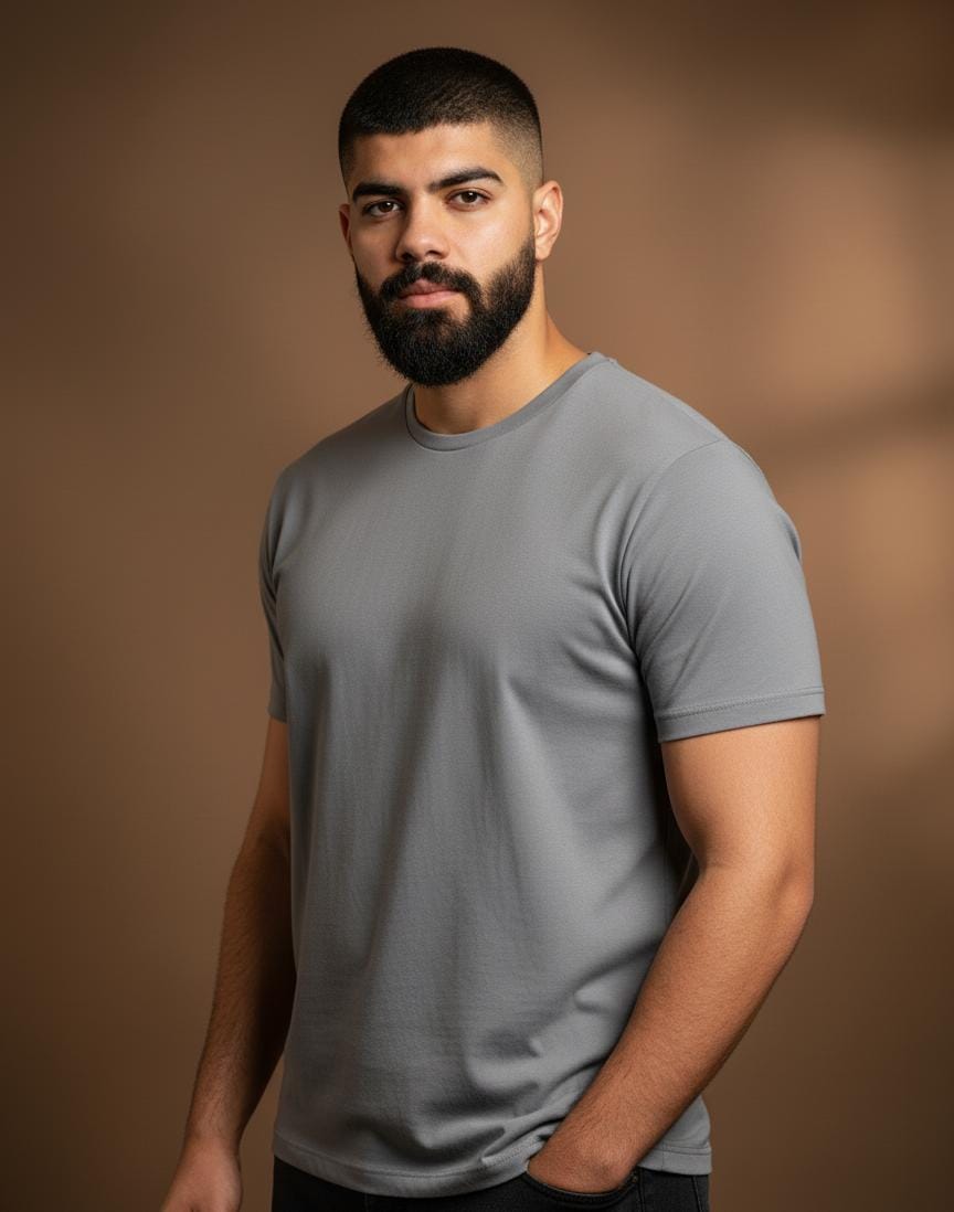 Man wearing a gray t-shirt against a brown background